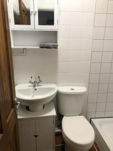 a bathroom with a toilet and a sink at Double Room with Private Bathroom in a 2-bedrooms house in London