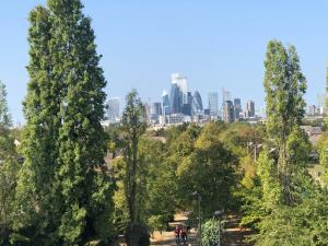 a view of the city from a park with trees at Double Room with Private Bathroom in a 2-bedrooms house in London