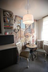 a dining room with a table and two chairs at Park View Apartment in Kaunas