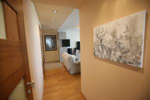 a living room with a couch and a painting on the wall at Park View Apartment in Kaunas