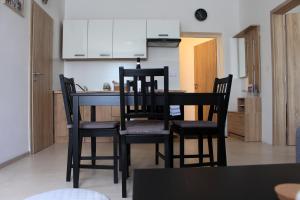a kitchen with a table and chairs in a room at Apartmány v podhradí in Bečov nad Teplou