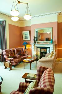 a living room with two couches and a fireplace at Aberdeen Lodge in Dublin
