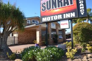 
a restaurant with a sign on the side of the building at Sunray Motor Inn in Toowoomba
