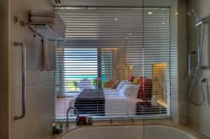 a bath tub with a window in a bathroom at Crowne Plaza Yas Island by IHG in Abu Dhabi