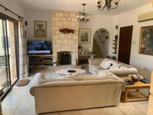 a living room with two couches and a fireplace at Villa Manzanillo in Coral Bay