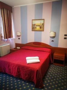 เตียงในห้องที่ Hotel Cavour Resort