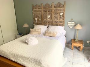 um quarto com uma cama grande com duas almofadas em la maison du bonheur em Saint-Pierre