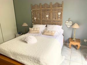 a bedroom with a large bed with two pillows on it at la maison du bonheur in Saint-Pierre +27 photos