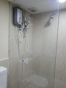 a bathroom with a shower with a phone on the wall at MercuryFM 101 Yarl Mercury Inn - Jaffna in Jaffna