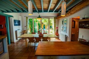 a kitchen and dining room with a table and chairs at Holiday Home Les Plachettes in Flobecq