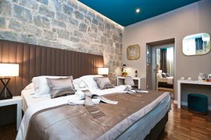 Posteľ alebo postele v izbe v ubytovaní Riva Luxury Rooms