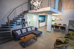 a living room with a couch and a staircase at Mein Beach House in Löbnitz