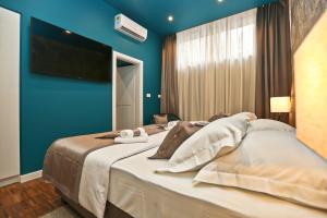 Posteľ alebo postele v izbe v ubytovaní Riva Luxury Rooms