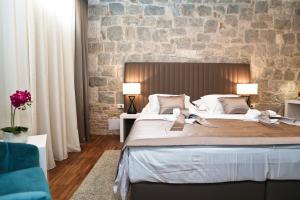 Posteľ alebo postele v izbe v ubytovaní Riva Luxury Rooms