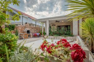 a house with a garden with flowers in the foreground at Jelena Sumartin in Sumartin