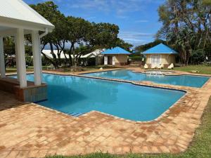an image of a swimming pool with a gazebo at The Villa at Caribbean Estates in Port Edward