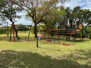 a park with a playground with colorful swings at The Villa at Caribbean Estates in Port Edward