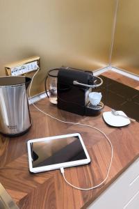 a tablet sitting on top of a wooden counter top at Palazzo D'Ambra Residenza d'Epoca in Florence