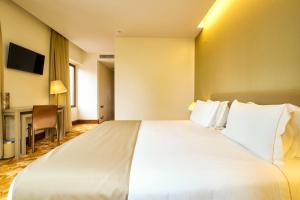 a large white bed in a hotel room at Sintra Boutique Hotel in Sintra