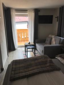 a living room with a couch and a table at Apart am Inn in Pfunds