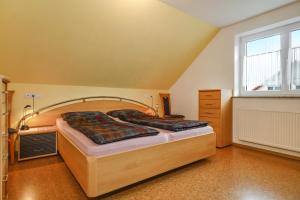 a large bed in a room with a large window at Ferienwohnung Merk in Neukirch