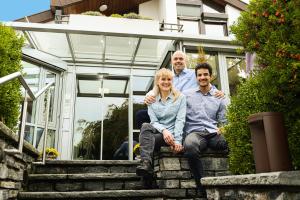 a man and a woman sitting on the steps of a house at Boutique-Hotel im Weingarten in Müllheim