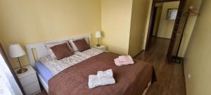 a bedroom with a large bed with towels on it at Sauliaus apartamentai VIP in Panevėžys