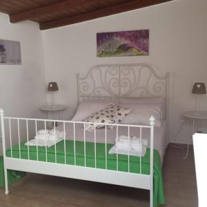シラクーサにあるCasa Vacanza Vivaldi Siracusaのベッドルーム1室(白いベッド1台、テーブル2台付)