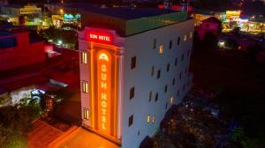a building with a neon sign on it at night at SUN HOTEL in Thu Dau Mot