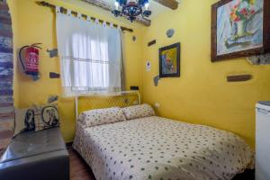a small bedroom with a bed and a window at Casa Carmelita in La Guancha