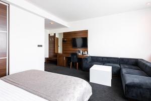 Postel nebo postele na pokoji v ubytování Tempus Club Garni Hotel