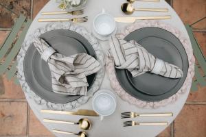 a table with plates and utensils on a table at Nima Local House Hotel & Spa in Mexico City +64 photos