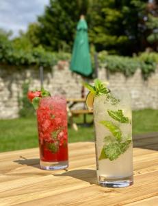 two cocktails sitting on a wooden table at The Frampton Arms in Dorchester