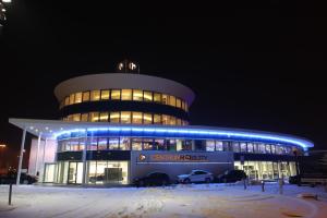 a building with cars parked in front of it at night at Tempus Club Garni Hotel in Bratislava