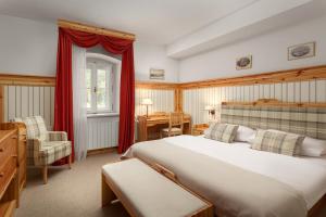 a bedroom with a large bed and a desk at Skalní Mlýn Adršpach in Adršpach