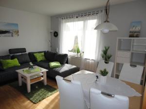 a living room with a couch and a table at Haus Sandra Ferienwohnung 2 in Dahme