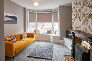 a living room with a couch and a window at Host & Stay - Fly Away at Ruby in Saltburn-by-the-Sea