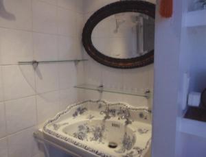 a bathroom with a sink and a mirror at Au Soleil Couchant in Trouville-sur-Mer