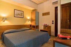 Letto o letti in una camera di Hotel Vello d'Oro