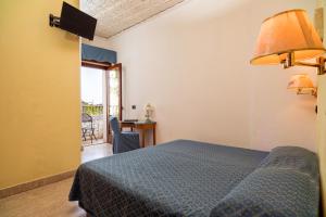 Letto o letti in una camera di Hotel Vello d'Oro