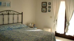 a bedroom with a bed and a window at Mafrolla Carlo in Vieste