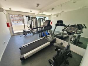 a gym with several tread machines and a mirror at Exclusivo estudio a metros de la Rural y la Embajada in Buenos Aires