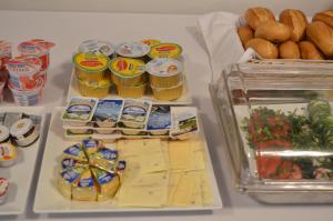 a refrigerator filled with cheese and other food items at POD DĘBEM in Osowa