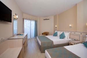 A bed or beds in a room at Narcia Resort Side - Ultra All Inclusive