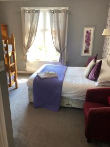 A bed or beds in a room at The Ardingly Inn 