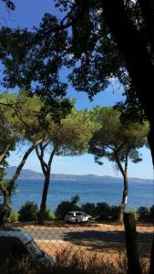 a car parked in a parking lot near the water at Guest House Bracciano RM in Bracciano