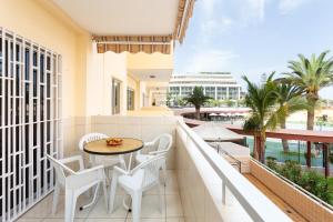 a balcony with a table and chairs and a view of the water at LOS ANGELES Holiday Home in Los Cristianos