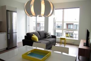 a living room with a couch and a table at Lotus Loft in Victoria