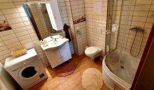 a bathroom with a toilet and a sink and a shower at Relax Apartman in Siófok +28 photos