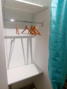 a closet with a white shelf and orange shoes at Studio 28m² au pied de la défense in Courbevoie